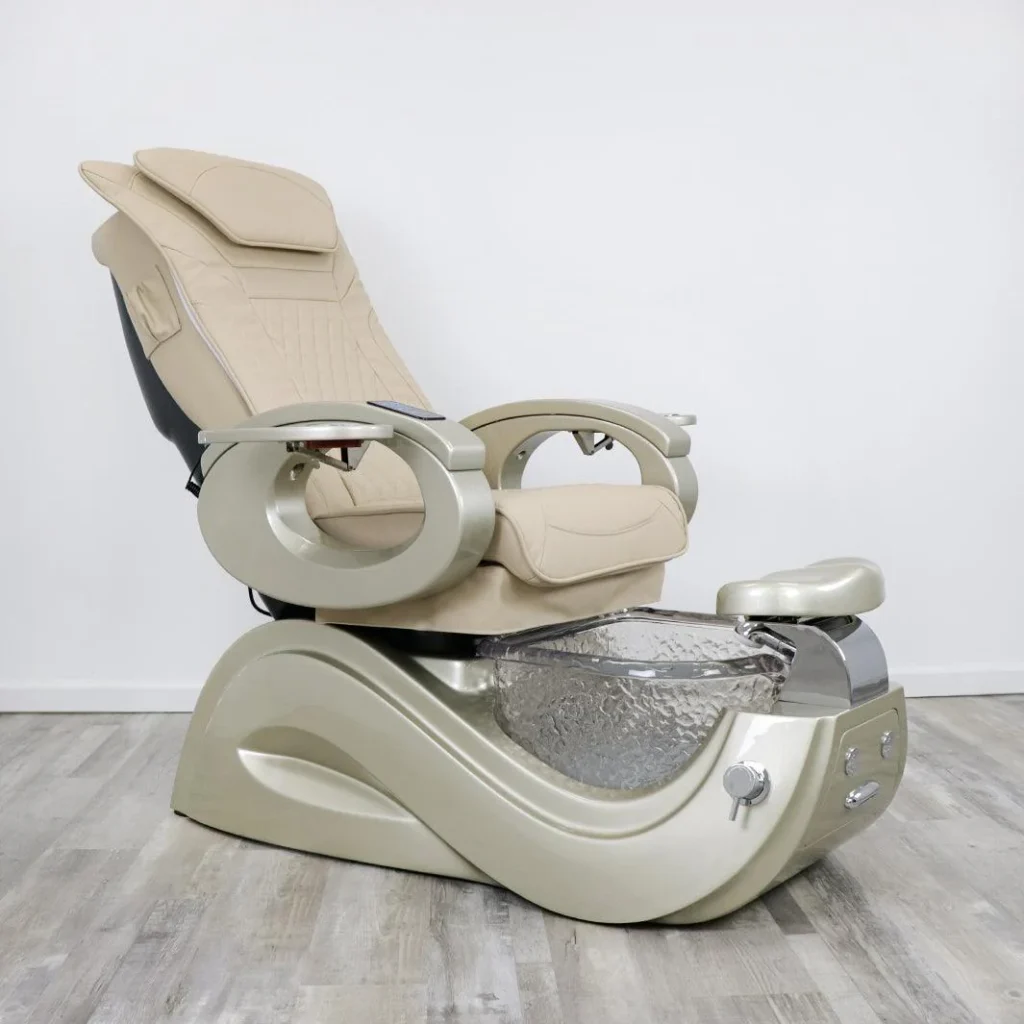 A sleek, contemporary pedicure massage chair from the James Barber Shop, placed in a spacious, well-lit salon. Soft, ambient lighting highlights the chair's plush, ergonomic design with a high-backed headrest and contoured armrests. The chair's massage mechanisms are visible, hinting at the soothing experience awaiting the user. The background features a minimalist, tile-floored setting, allowing the chair to take center stage. The overall atmosphere conveys a sense of relaxation and indulgence, perfectly suited for the "How to Choose the Right Pedicure Massage Chair" section.