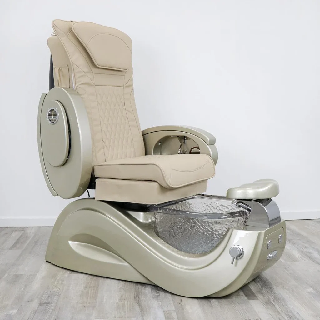 A luxurious pedicure spa chair set in a serene, minimalist James Barber Shop interior. Soft, indirect lighting creates a warm, relaxing ambiance. The chair is crafted from high-quality, plush materials in a neutral color palette, inviting the customer to sink in and unwind. In the foreground, a polished metal footrest and a tray of pedicure tools suggest the indulgent treatments to come. The middle ground features a sleek, wooden side table with refreshments, while the background showcases the shop's clean, contemporary design with subtle branding elements.