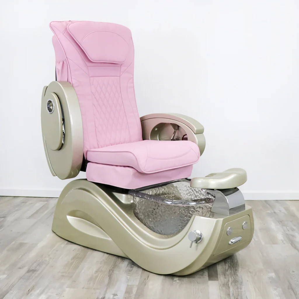 A luxurious, modern pedicure chair from the James Barber Shop, with a plush, ergonomic design in a sleek, brushed metal frame. The chair is positioned in a serene, dimly lit spa-like setting, accented by soft, warm lighting from sconces on the walls. The chair is surrounded by lush, potted plants, creating a calming, natural ambiance. The polished marble floor reflects the chair's elegant silhouette, while the neutral-toned walls provide a sophisticated backdrop. The overall atmosphere evokes a sense of tranquility and indulgence, perfectly suited for a pampering pedicure experience.