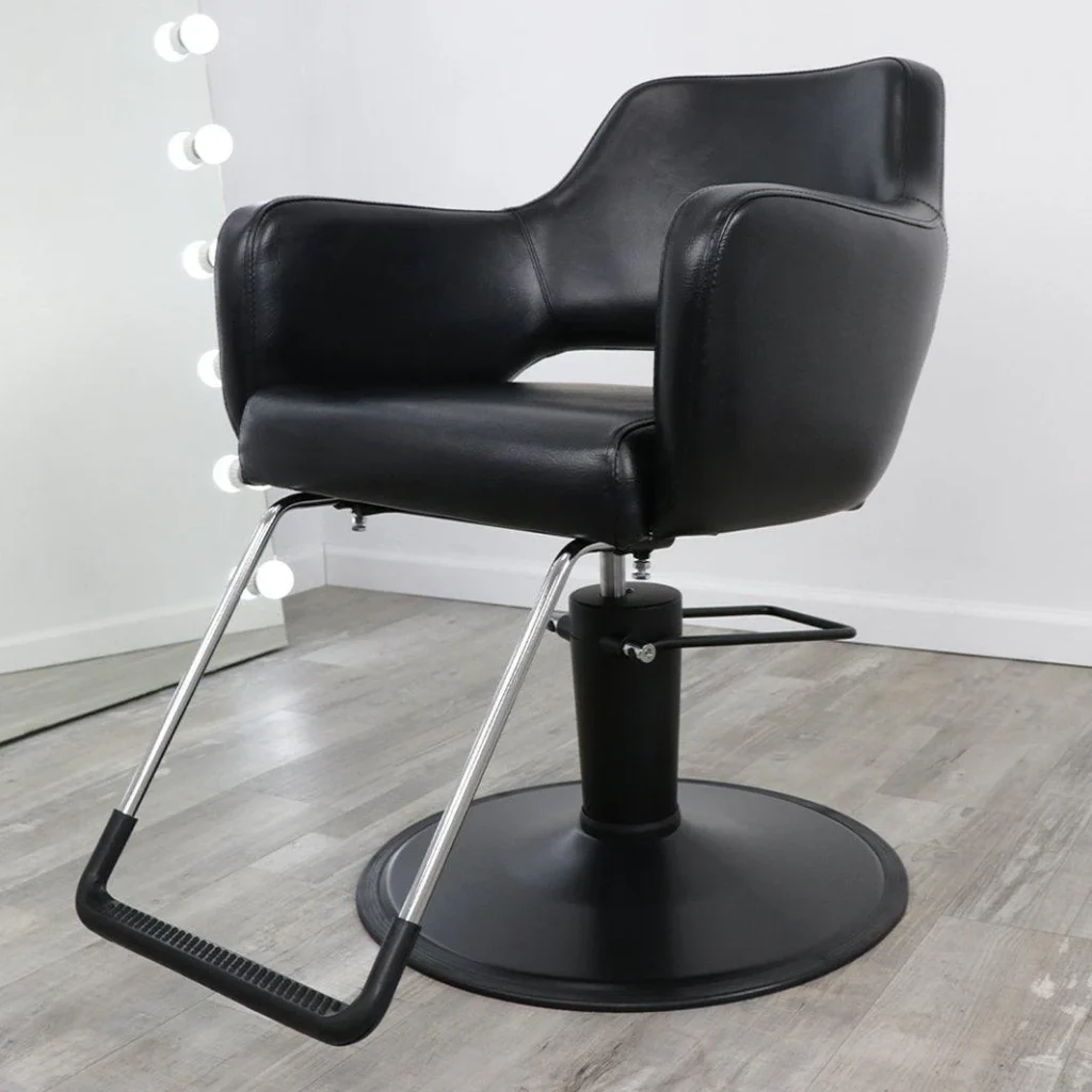 A modern, well-lit salon featuring a row of high-quality, plush salon chairs from the "James Barber Shop" brand. The chairs are positioned against a warm, neutral-toned backdrop, with a mix of muted colors and subtle textures that create a calming, professional atmosphere. The chairs have a sleek, contemporary design with adjustable headrests and armrests, and are upholstered in a durable, easy-to-clean material. Soft, directional lighting from above casts a flattering glow on the chairs, highlighting their premium features and inviting customers to relax and enjoy their salon experience.