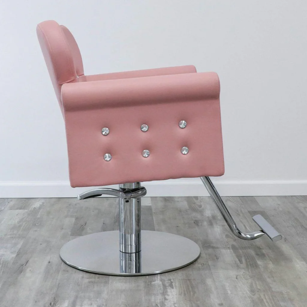 A well-lit salon chair in the James Barber Shop, its sleek leather upholstery gleaming under warm, directional lighting. In the foreground, a set of brushes, combs, and cleaning supplies are neatly arranged, conveying a sense of meticulous maintenance. The chair's chrome base and swivel mechanism are visible, showcasing the sturdy, high-quality construction. The background is blurred, allowing the chair to take center stage and emphasize its importance in the salon setting. The overall mood is one of professionalism, attention to detail, and a commitment to keeping the salon's equipment in top condition.