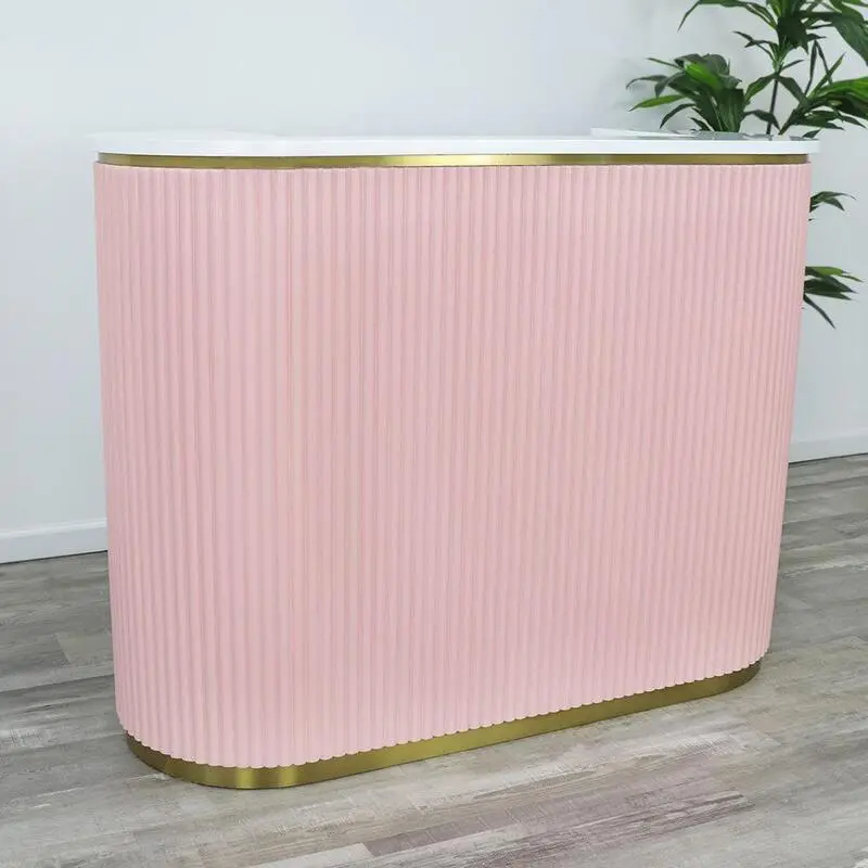 A modern, well-designed salon reception desk situated in a bright, airy space. The desk features a sleek, minimalist design with a smooth, wooden countertop and clean lines. The front of the desk is adorned with a subtle, elegant logo or branding. Behind the desk, the wall is adorned with a soothing, neutral-toned wallpaper or artwork, adding a touch of sophistication. The lighting is a combination of soft, indirect overhead lighting and task lighting on the desk, creating a warm, inviting atmosphere. The desk is positioned in the center of the frame, with the background blurred to focus the viewer's attention on the centerpiece of the salon's entrance.
