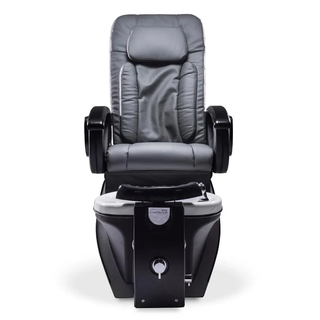A luxurious, high-end pedicure spa chair from the James Barber Shop, bathed in warm, soft lighting. The chair is made of premium, tufted leather in a rich, deep burgundy hue, with intricate stitching details. Smooth, curved armrests and a gently reclined backrest invite the user to sink into pure comfort. The chair is positioned in a serene, minimalist setting, with a sleek, marble-topped pedicure station in the foreground and a soothing, neutral-toned backdrop. The overall atmosphere exudes a sense of tranquility and indulgence, perfectly suited for a premium salon experience.